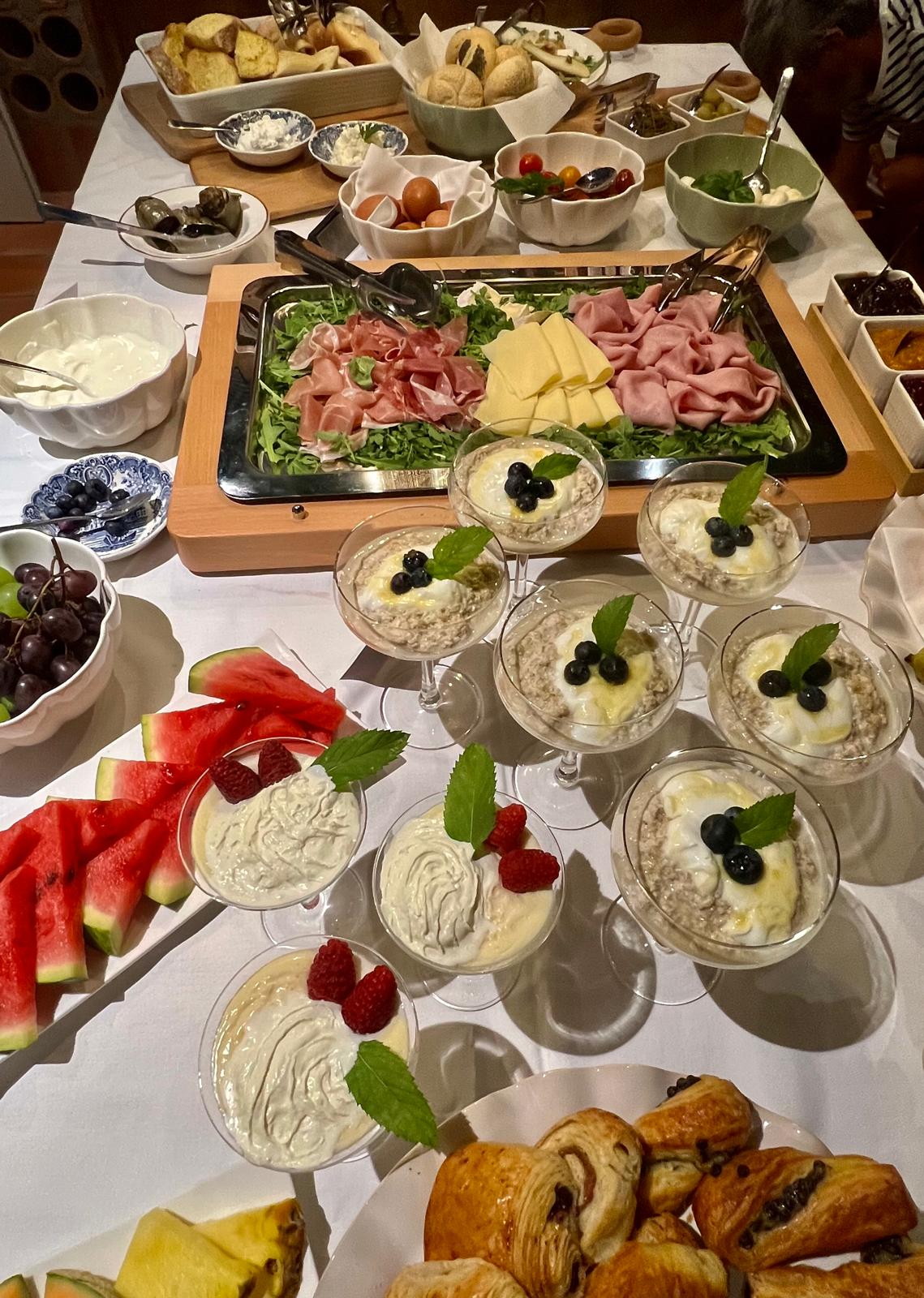 Breakfast buffet with pastries, fruit and yoghurt at Villa Adora