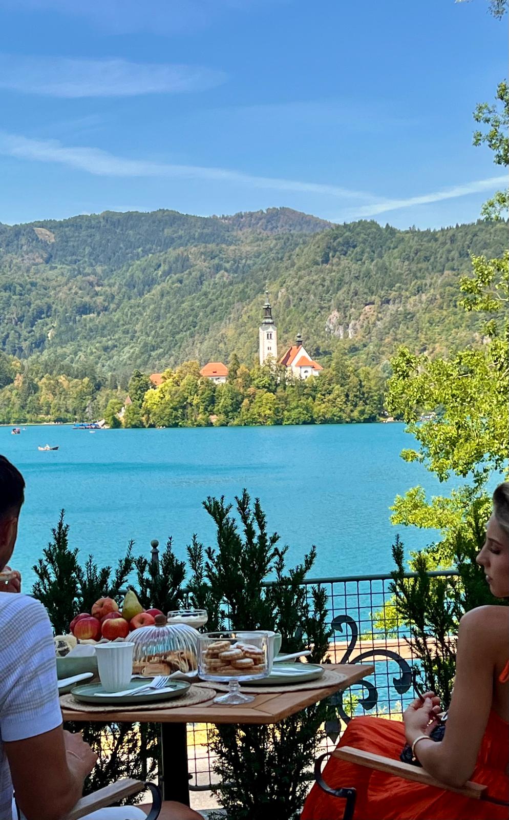 Guests enjoying breakfast beside Lake Bled